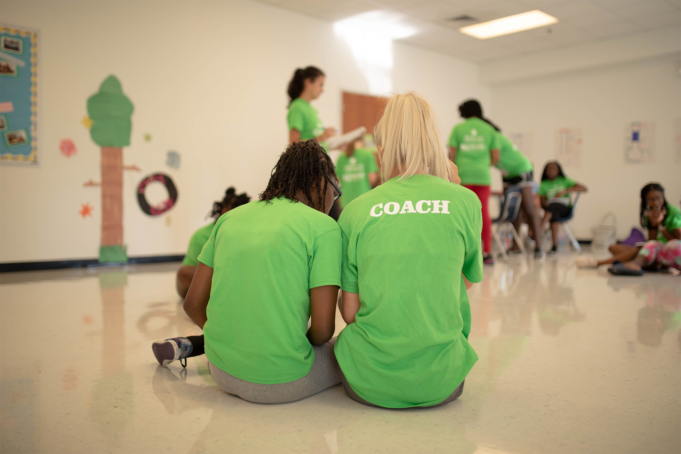 Coach and girl sitting together